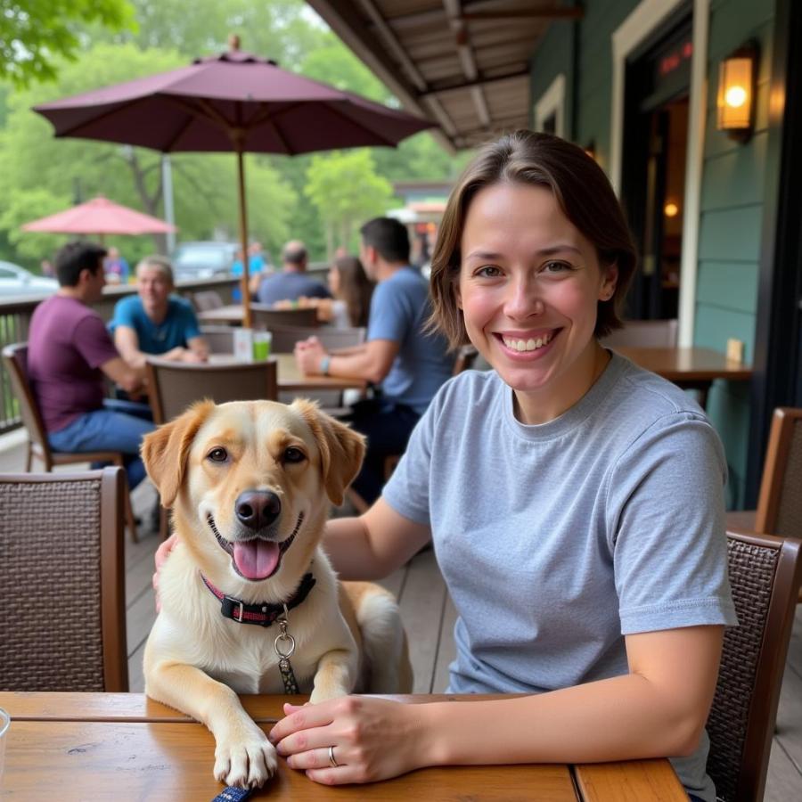 Dog sitting with owner on a patio